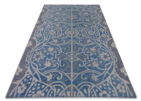 The center line divides the carpet into two mirror designs and together they complete the full carpet. The floral vine is inspired from traditional European vines but has contemporary touch to it. The colours are subdued so that the design emerges more significantly.
